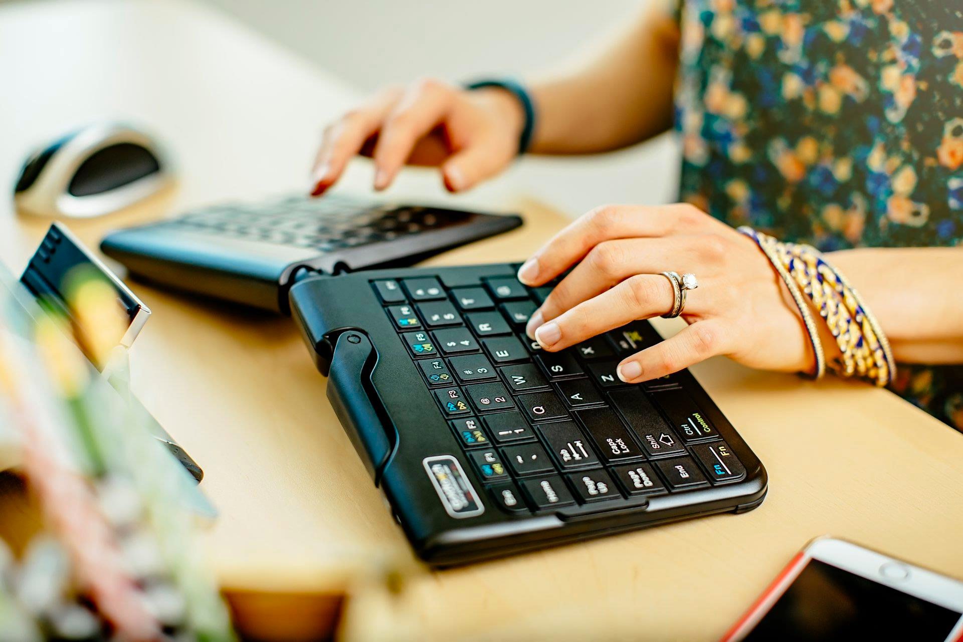 A woman using a split keyboard