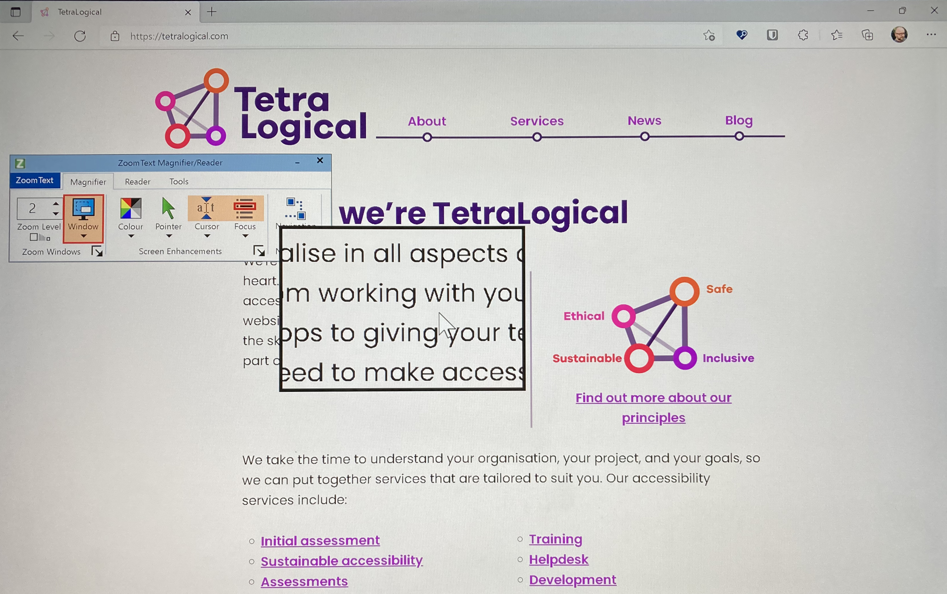 The TetraLogical homepage with the ZoomText magnifier highlighting one part of the page